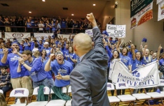 Dakota Wesleyan Head Coach Matt Wilber gives a fist pump to the crowd after their win against the College of Idaho on Saturday during the third round of the NAIA Division II National Championship Tournament in the Keeter Gymnasium on the campus of the College of the Ozarks in Point Lookout, Mo. (Matt Gade/Republic)