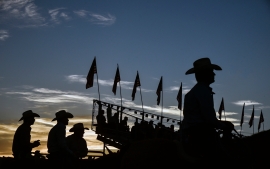 Cowboys watch the action as the sunsets on the final night of the Corn Palace Stampede Rodeo on Sunday, July 17 at Horseman's Sports Arena in Mitchell.