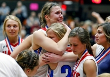 Sanborn Central/Woonsocket's Myah Selland (44) hugs her teammate Madi Moody after the Blackhawks fell to the Sully Buttes Chargers in the Class B state championship game on Saturday night at the Huron Arena.