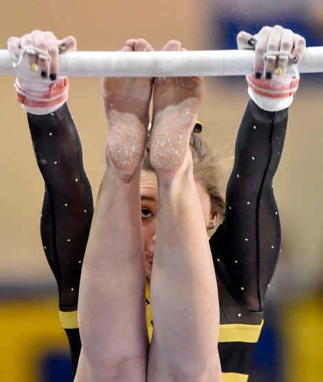 Mitchell's Maria Krall performs on the bars during the state gymnastics meet on Friday at the Golden Eagles Arena in Aberdeen.