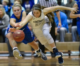 Dakota Wesleyan's Sarah Carr (40) and Concordia's Colby Duvel (50) scramble for a loose ball during a Great Plains Athletic Conference game on Sunday at the Corn Palace.