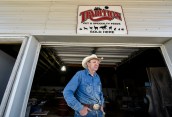 Lonnie Smith, owner of Drifting Cowboy Saddle Shop, stands in the doorway to the workshop, a rented out former feed shop, right across the street from his main shop in Ree Heights. In the slowly shrinking town of Ree Heights, pop. 60, Smith didn't want to move out of town when he realized he needed more space for his shop and approached the owners of the former feed shop who Smith said were happy to rent it out to someone in town.